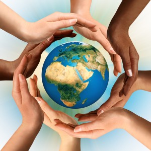 Conceptual symbol of multiracial human hands surrounding the Earth globe. Unity, world peace, humanity concept.